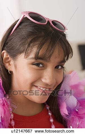 Portrait of smiling girl (10-11) wearing feather boa and sunglasses View Large Photo Image Stock Photo - Portrait of smiling girl (10-11) wearing feather boa and sunglasses. Fotosearch