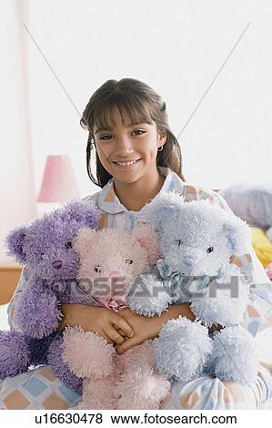 Portrait of smiling girl (10-11) holding puppets View Large Photo Image Stock Photo - Portrait of smiling girl (10-11) holding puppets. Fotosearch