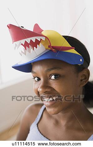 Portrait of smiling girl (10-11) wearing funny hat View Large Photo Image Stock Photography - Portrait of smiling girl (10-11) wearing funny hat. Fotosearch