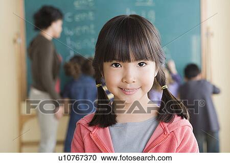 Portrait of smiling girl (6-7) with classmates in background View Large Photo Image Stock Image - Portrait of smiling girl (6-7) with classmates in background. Fotosearch