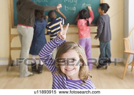 Portrait of smiling girl (6-7) with schoolmates in background View Large Photo Image Stock Photography - Portrait of smiling girl (6-7) with schoolmates in background. Fotosearch