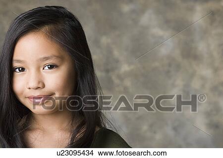 Picture - Portrait of smiling girl (8-9), studio shot. Fotosearch