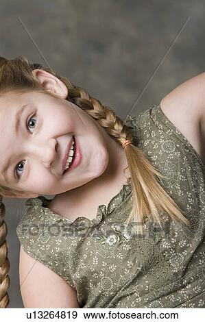 Portrait of smiling girl (8-9), studio shot View Large Photo Image Stock Photo - Portrait of smiling girl (8-9), studio shot. Fotosearch