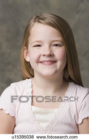 Portrait of smiling girl (8-9), studio shot View Large Photo Image Stock Photo - Portrait of smiling girl (8-9), studio shot. Fotosearch