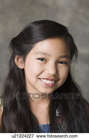 Portrait of smiling girl (8-9), studio shot View Large Photo Image Stock Photo - Portrait of smiling girl (8-9), studio shot. Fotosearch