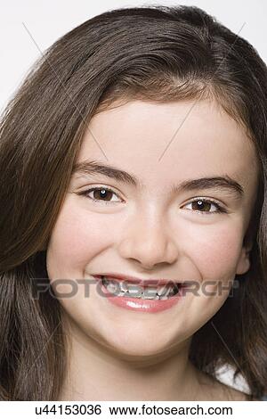 Portrait of smiling girl (8-9), studio shot View Large Photo Image Stock Photograph - Portrait of smiling girl (8-9), studio shot. Fotosearch