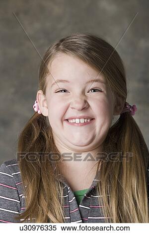 Portrait of smiling girl (8-9), studio shot View Large Photo Image Stock Photography - Portrait of smiling girl (8-9), studio shot. Fotosearch