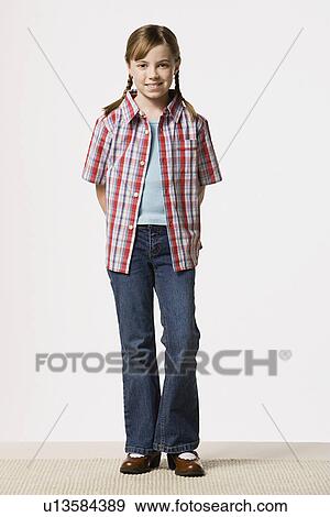 Portrait of smiling girl (8-9) wearing checked shirt, studio shot View Large Photo Image Stock Photo - Portrait of smiling girl (8-9) wearing checked shirt, studio shot. Fotosearch
