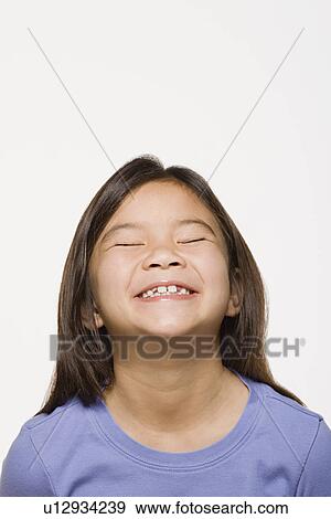 Portrait of smiling girl (8-9) with eyes closed, studio shot View Large Photo Image Stock Photo - Portrait of smiling girl (8-9) with eyes closed, studio shot. Fotosearch