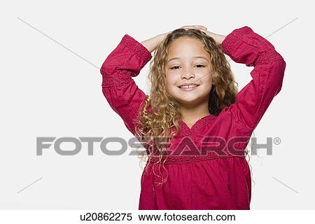 Portrait of smiling girl (8-9) with hands on head, studio shot View Large Photo Image Stock Photography - Portrait of smiling girl (8-9) with hands on head, studio shot. Fotosearch