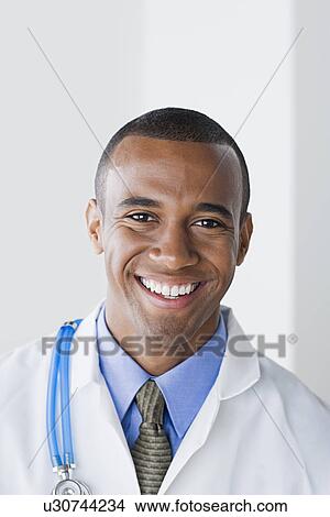 Portrait of smiling male doctor View Large Photo Image Picture - Portrait of smiling male doctor. Fotosearch