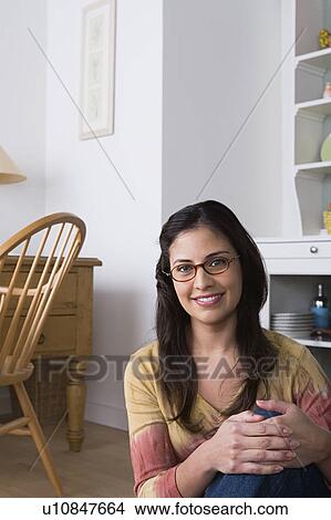 Picture - Portrait of smiling woman at home. Fotosearch