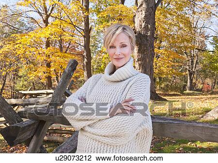 Portrait of smiling woman in Autumn forest View Large Photo Image Stock Image - Portrait of smiling woman in Autumn forest. Fotosearch