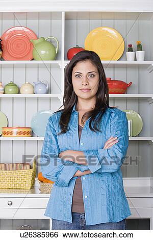 Portrait of smiling woman in kitchen View Large Photo Image Stock Photograph - Portrait of smiling woman in kitchen. Fotosearch