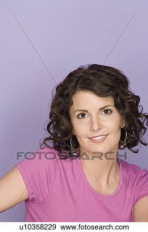 Portrait of smiling woman on purple background, studio shot View Large Photo Image Stock Photo - Portrait of smiling woman on purple background, studio shot. Fotosearch