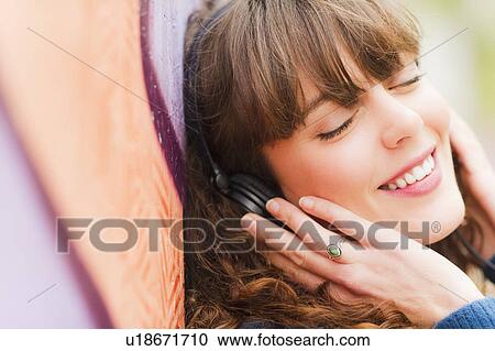 Portrait of smiling woman with headphones View Large Photo Image Stock Image - Portrait of smiling woman with headphones. Fotosearch
