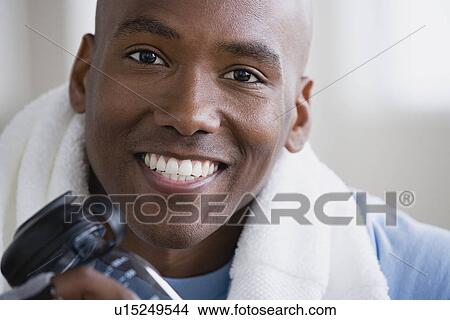Portrait of smiling young man in gym View Large Photo Image Picture - Portrait of smiling young man in gym. Fotosearch