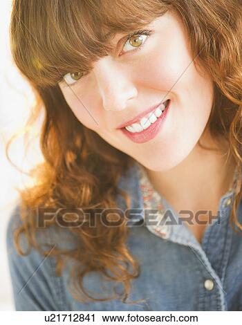 Stock Image - Portrait of smiling young woman. Fotosearch