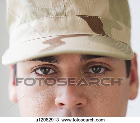 Stock Image - Portrait of soldier, studio shot. Fotosearch