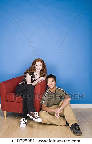Portrait of teenage (16-17) girl and teenage boy (16-17) sitting together View Large Photo Image Stock Image - Portrait of teenage (16-17) girl and teenage boy (16-17) sitting together. Fotosearch
