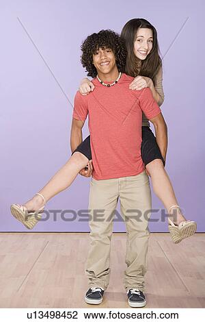 Portrait of teenage (16-17) girl and teenage boy (14-15) enjoying together View Large Photo Image Stock Image - Portrait of teenage (16-17) girl and teenage boy (14-15) enjoying together. Fotosearch