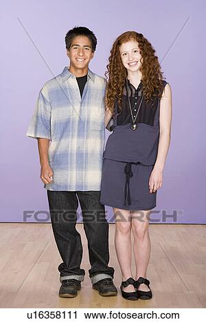 Portrait of teenage (16-17) girl and teenage boy (16-17) standing together View Large Photo Image Stock Image - Portrait of teenage (16-17) girl and teenage boy (16-17) standing together. Fotosearch