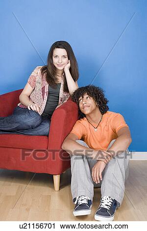 Portrait of teenage (16-17) girl and teenage boy (14-15) sitting together View Large Photo Image Stock Image - Portrait of teenage (16-17) girl and teenage boy (14-15) sitting together. Fotosearch