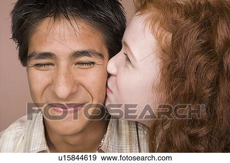 Portrait of teenage (16-17) girl kissing teenage boy (16-17) View Large Photo Image Stock Photo - Portrait of teenage (16-17) girl kissing teenage boy (16-17). Fotosearch
