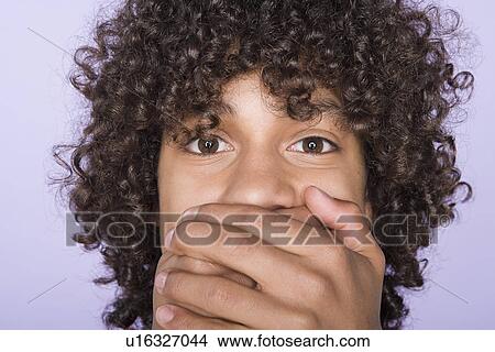 Portrait of teenage boy (14-15) covering mouth with hands View Large Photo Image Picture - Portrait of teenage boy (14-15) covering mouth with hands. Fotosearch