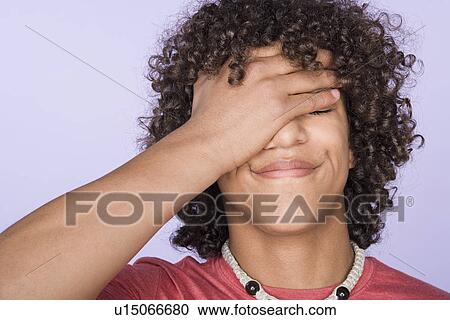 Portrait of teenage boy (14-15) covering eyes with hand View Large Photo Image Stock Image - Portrait of teenage boy (14-15) covering eyes with hand. Fotosearch