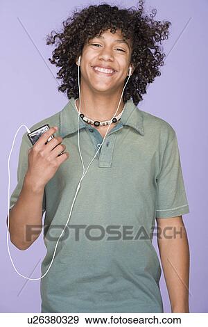 Portrait of teenage boy (14-15) listening music View Large Photo Image Stock Photo - Portrait of teenage boy (14-15) listening music. Fotosearch