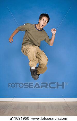 Portrait of teenage boy (16-17) jumping View Large Photo Image Stock Image - Portrait of teenage boy (16-17) jumping. Fotosearch