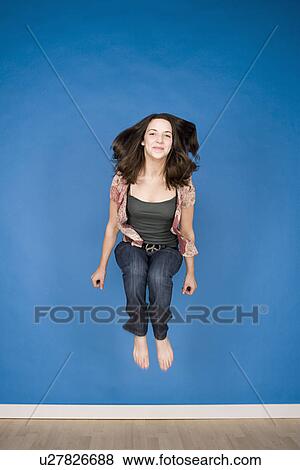 Portrait of teenage girl (16-17) jumping View Large Photo Image Stock Photo - Portrait of teenage girl (16-17) jumping. Fotosearch