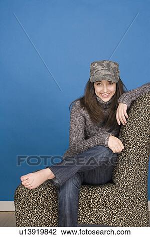Stock Image - Portrait of teenage girl (16-17) sitting. Fotosearch