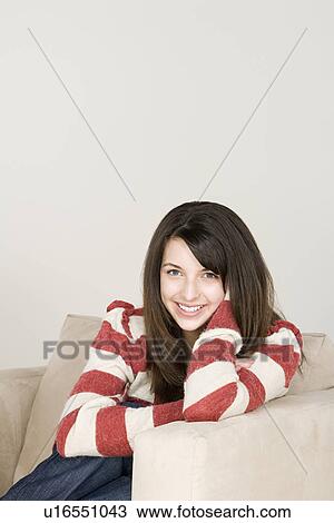 Portrait of teenage girl (16-17) sitting in armchair View Large Photo Image Stock Image - Portrait of teenage girl (16-17) sitting in armchair. Fotosearch
