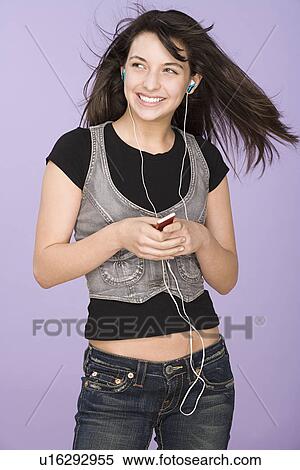 Portrait of teenage girl (16-17) listening to mp3 player View Large Photo Image Stock Photography - Portrait of teenage girl (16-17) listening to mp3 player. Fotosearch