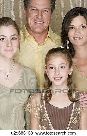 Stock Photo - Portrait of three generation family with two girls (8-9, 14-15). Fotosearch