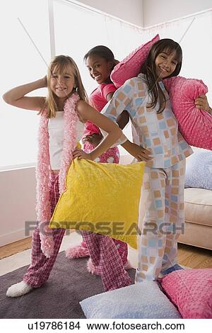 Portrait of three girls (10-11) playing at slumber party View Large Photo Image Picture - Portrait of three girls (10-11) playing at slumber party. Fotosearch