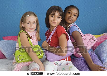 Portrait of three girls (10-11) wearing colorful purses View Large Photo Image Stock Image - Portrait of three girls (10-11) wearing colorful purses. Fotosearch
