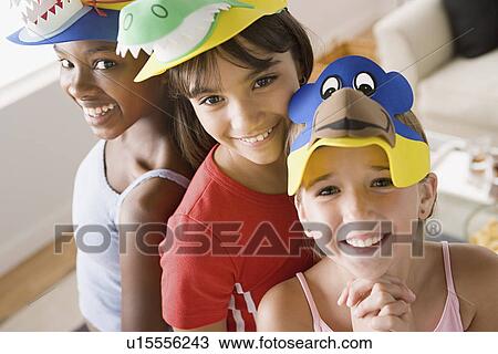 Portrait of three girls (10-11) wearing funny hats at slumber party View Large Photo Image Stock Image - Portrait of three girls (10-11) wearing funny hats at slumber party. Fotosearch