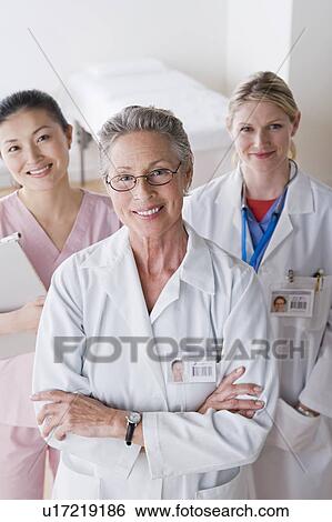 Portrait of three smiling female doctors View Large Photo Image Stock Photograph - Portrait of three smiling female doctors. Fotosearch