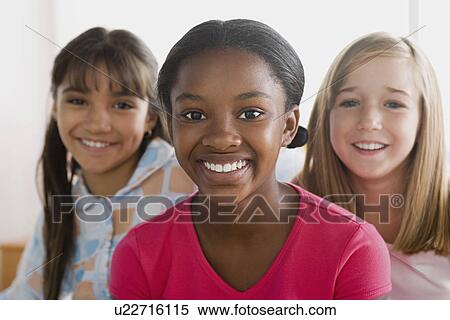 Stock Photography - Portrait of three smiling girls (10-11) . Fotosearch