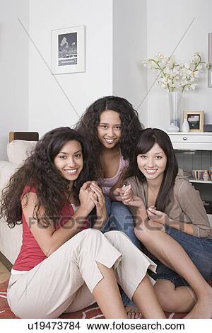 Portrait of three young women smiling View Large Photo Image Picture - Portrait of three young women smiling. Fotosearch