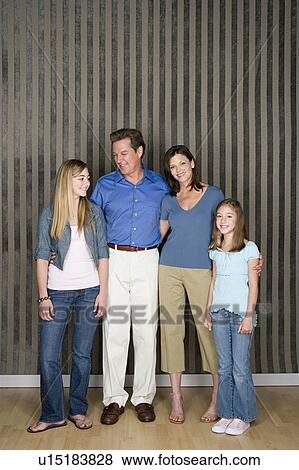 Stock Photo - Portrait of two generation family with two daughters (8-9, 14-15). Fotosearch