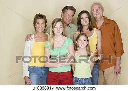 Stock Photo - Portrait of two generation family with two girls (8-9, 14-15). Fotosearch