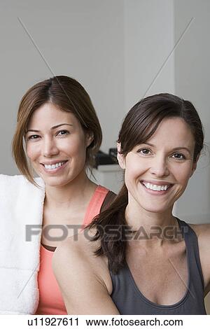 Portrait of two smiling women in gym View Large Photo Image Stock Image - Portrait of two smiling women in gym. Fotosearch