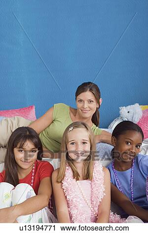 Portrait of woman and three girls (10-11) at slumber party View Large Photo Image Stock Image - Portrait of woman and three girls (10-11) at slumber party. Fotosearch