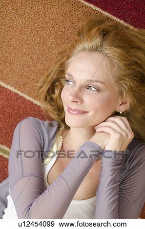 Portrait of woman lying on floor View Large Photo Image Stock Photo - Portrait of woman lying on floor. Fotosearch