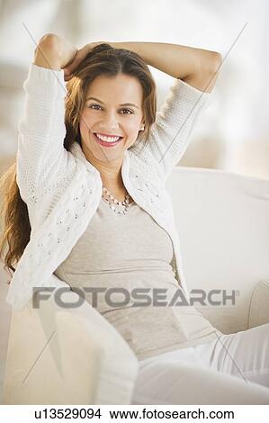 Portrait of woman relaxing in chair View Large Photo Image Picture - Portrait of woman relaxing in chair. Fotosearch