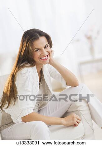 Portrait of woman relaxing in chair View Large Photo Image Stock Image - Portrait of woman relaxing in chair. Fotosearch